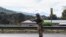 FILE - A member of the community police patrols the road in Cheran, Michoacan state, Mexico, Dec. 11, 2019.