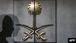 The shadow of a security guard is seen on the entrance door of the Saudi Arabia's consulate in Istanbul, on Oct. 12, 2018.