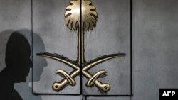 FILE - The shadow of a security guard is seen on the entrance door of the Saudi Arabia's consulate in Istanbul, on Oct. 12, 2018.