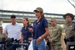 FILE - South Dakota Governor Kristi Noem, center, is joined by other Republican governors as she speaks during a news conference along the Rio Grande on Aug. 21, 2023, in Eagle Pass, Texas.