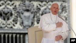 FILE - Pope Francis makes the sign of the cross during his weekly general audience, in St. Peter's Square, at the Vatican, May 8, 2019. 