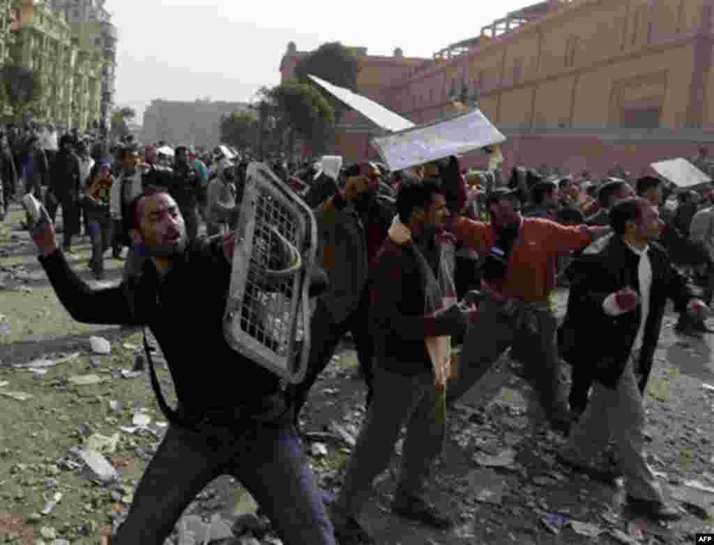 Anti-government protestors throw stones during clashes in Cairo, Egypt, Thursday, Feb. 3, 2011. Egypt's prime minister apologized for an attack by government supporters on protesters in a surprising show of contrition Thursday, and the government offered 