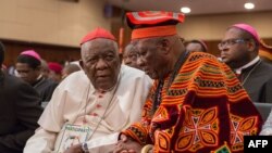 FILE - Cardinal Christian Wiyghan Tumi (L) talks with Cameroonian veteran opposition leader John Fru Ndi as they attends at the Congress Palace during the opening session of the National Dialogue called by President Biya, in Yaounde, Sept. 30, 2019.