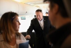 FILE - U.S. Secretary of State Mike Pompeo walks towards reporters to speak aboard his plane en route to Thailand, before taking off from Andrews Air Force Base, Md.