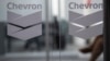 FILE - Chevron Global Technology Services Company logos are seen at an administrative office in Caracas, Venezuela, on Nov. 29, 2022. 