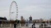 FILE - Women wear face coverings as they walk in London, Friday, Nov. 20, 2020.