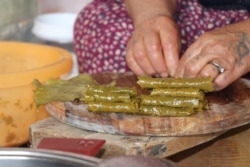 Ismahan says grape leaves rolled with rice and some yogurt is all she can afford for the day, in Istanbul, May 20, 2020. (VOA/Heather Murdock)