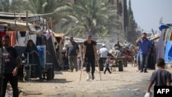 (FILE) Displaced Palestinians prepare to leave the perimeter of the Al-Aqsa Martyrs Hospital in Deir al-Balah in the central Gaza Strip on August 26, 2024. 