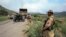 A soldier keeps guard near a truck transporting ammunition to an army base camp in Tora Warai, a town in Kurram Agency, during a military trip organised for media along the Pakistan Afghanistan border July 10, 2011.The Pakistan Army said on July 4 that it