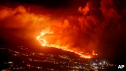 FILE - Lava flows as volcano continues to erupt on the Canary island of La Palma, Spain, Tuesday, Nov. 30, 2021. 