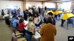 Voters cast their ballot on the Super Tuesday, at a voting center in Alhambra, Calif., March 3, 2020. 