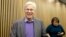 FILE - Finnish Professor Bengt Holmstrom of the Massachusetts Institute of Technology smiles as he departs a news conference after speaking to members of the media on the campus of MIT in Cambridge, Massachusetts, Oct. 10, 2016.