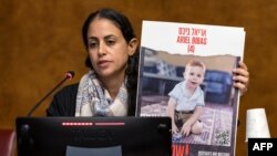 FILE —Ofri Bibas Levy, Sister of Yarden Bibas held hostage with his wife and two children Kfir and Ariel in the Gaza Strip by Palestinian militant group Hamas after the October 7 attack, speaks at the European Office of Nations, Palais des Nation, in Geneva on November 14, 2023.