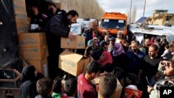 Workers distribute aid items from UNICEF to Syrian refugees at a camp in the town of Bar Elias, Bekaa Valley, Lebanon, Jan. 10, 2019.