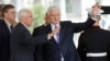 Vice President Mike Pence, left, with Prime Minister of Montenegro Dusko Markovic, center, wave to members of the media outside the West Wing of the White House in Washington, June 5, 2017.