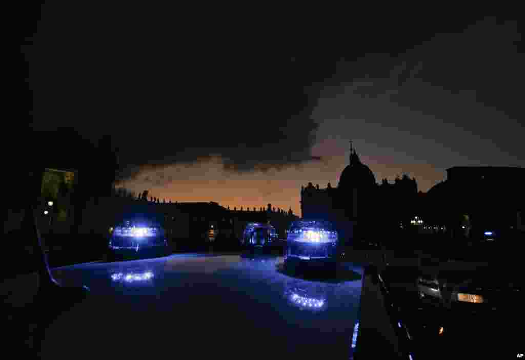 Carabinieri (Italian paramilitary police) car&#39;s blue lights flash in front of St. Peter&#39;s Basilica, in Rome, Italy. Extra pilgrims and tourists coming for the Holy Year, which runs through Nov. 20, 2016, pose challenging logistics for both Vatican and Italian security forces.