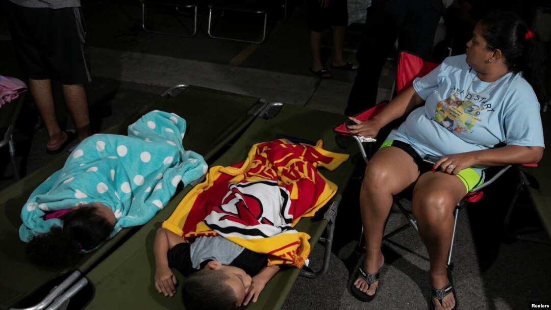 People rest at a makeshift camp outside their apartment building after an earthquake in Yauco, Puerto Rico, Jan. 7, 2020.