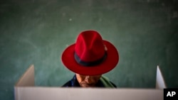 FILE - A voter fills out a ballot paper during general elections in Nkandla, Kwazulu Natal, South Africa, May 29, 2024. 