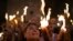 FILE—A Christian Orthodox pilgrim holds a candle during the Holy Fire ceremony at the Church of the Holy Sepulchre, where many Christians believe Jesus was crucified, buried and rose from the dead, in the Old City of Jerusalem. Saturday, May 4, 2024. 