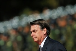 Brazil's President Jair Bolsonaro looks on during an Soldier's Day ceremony, in Brasilia, Brazil, Aug. 23, 2019.