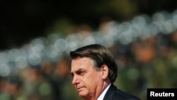 Brazil's President Jair Bolsonaro looks on during an Soldier's Day ceremony, in Brasilia, Brazil, Aug. 23, 2019.