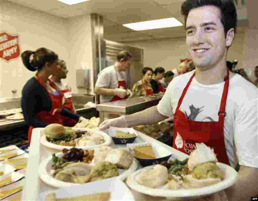 COMMERCIAL IMAGE In this photograph taken by AP Images for Nickelodeon, Logan Henderson of Big Time Rush helps serve a Thanksgiving lunch at The Salvation Army on Thursday, Nov. 24, 2011 in Dallas. (Brandon Wade/AP for Nickelodeon)