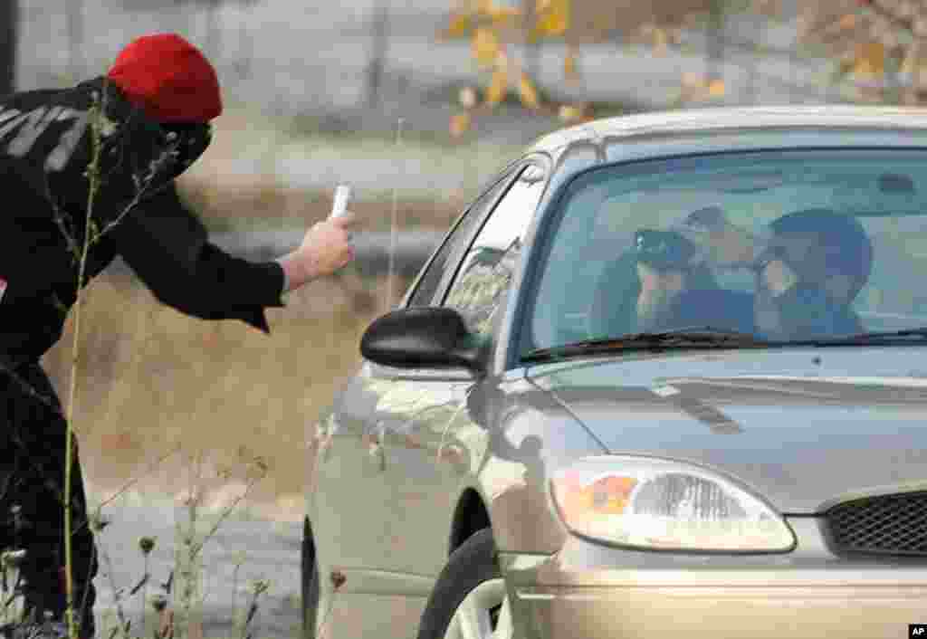 Dec. 12: A protester and a law enforcement officer photograph each other across from the entrance to the terminals at the Port of Longview. (Reuters)