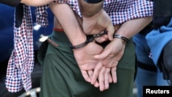 FILE - U.S. Immigration and Customs Enforcement officers make an arrest in California in May 2017.