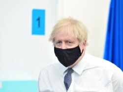 FILE - Britain's Prime Minister Boris Johnson visits a coronavirus vaccination site at the Business Design Centre in Islington, London, Britain, May 18, 2021.