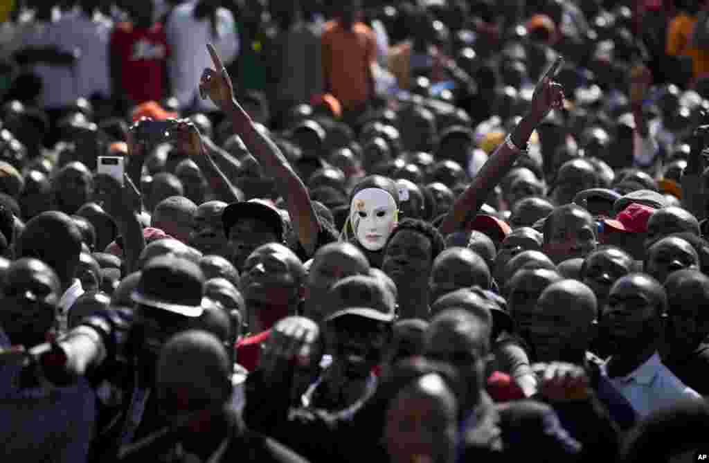 An opposition supporter wears a white mask during a rally for opposition leader Raila Odinga to commemorate Madaraka Day, when Kenya attained internal self-rule in 1963, at Uhuru Park in Nairobi, Kenya.