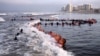 FILE - In this May 4, 2020, photo provided by the U.S. Navy, SEAL candidates participate in "surf immersion" during Basic Underwater Demolition/SEAL training at the Naval Special Warfare Center in Coronado, California.