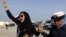 FILE - Bahraini opposition activist Zainab al-Khawaja, left, gestures as she shouts "God is greater than any tyrant," while being arrested by police officers in Bahrain, Oct. 21, 2012.