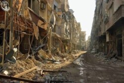 Damaged buildings line the street in Daraya after bombardment by the Syrian regime.
