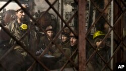 Ukrainian coal miners wait in a room before going underground at the Zasyadko mine in Donetsk, Ukraine, March 4, 2015. 