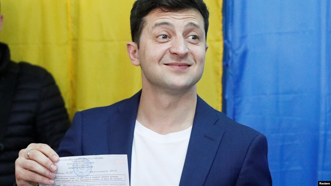 Calon presiden Ukraina Volodymyr Zelenzkiy menunjukkan surat suaranya kepada media di sebuah tempat pemungutan suara dalam pilpres putaran kedua di Kyiv, Ukraina, 21 April 2019.
