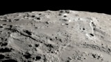 This image provided by NASA shows a view from orbit looking across the surface of the moon, where an ancient asteroid strike carved out a pair of grand canyons on the moon’s far side. (Ernie T. Wright/NASA via AP)