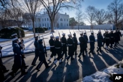 FILE - Members of the U.S. military Joint Honor Guard rehearse near the White House ahead of the upcoming presidential inauguration in Washington, Jan. 12, 2025.