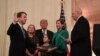 Brett Kavanaugh (L) is sworn-in as Associate Justice of the US Supreme Court by Associate Justice Anthony Kennedy (R) before wife Ashley Estes Kavanaugh (2nd-R), daughters Margaret (2nd-L) and Elizabeth (C), and US President Donald Trump at the White Hous