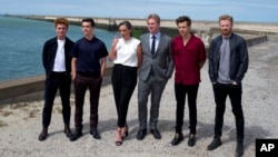 Left to right, Tom Glynn-Carney, Fionn Whitehead, Emma Thomas, director Christopher Nolan, Harry Styles and Jack Lowden pose for photographers upon arrival at the premiere of the movie "Dunkirk," in Dunkirk, northern France, July 16, 2017. The film, direc