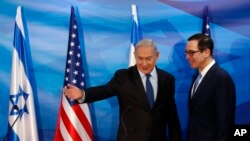 Israeli Prime Minister Benjamin Netanyahu gestures while standing next to U.S. Treasury Secretary Steven Mnuchin as they prepare to deliver joint statements during their meeting in Jerusalem, Oct. 28, 2019. 