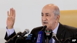 FILE - Algerian President Abdelmadjid Tebboune gestures during a press conference in Algiers, Friday, Dec. 13, 2019. 