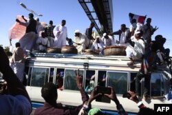 Sudanese protesters rally in front of a court in Omdurman near the capital Khartoum, Dec. 30, 2019, during the trial of intelligence agents for the death of teacher Ahmed Al-Khair while in custody of intelligence services.