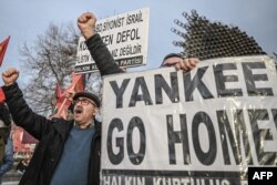 Demonstrators hold a placard reading "Yankee go home!" during a protest by the People's Liberation party against the visit of US State Secretary Anthony Blinken to Turkey at the Besiktas square in Istanbul, on January 6, 2024.