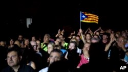 A man waves an Estelada or Independence flag during an event promoting the start of campaigning for a referendum on Catalonia's future status, in Tarragona, Spain, Sept. 14, 2017.