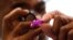 A technician adjusts the controls on a hearing device (file photo).