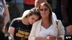 FILE - Members of the public gather outside Manchester Cathedral on May 22, 2018, the one year anniversary of the deadly attack at Manchester Arena.