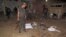 Security officials gather at the site of a suicide bomb blast in the outskirts of Dera Ismail Khan, Oct. 16, 2013. 