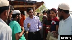 FILE - Rohingya Muslim leader Mohib Ullah speaks to other Rohingya people in Cox's Bazar, Bangladesh, April 7, 2019. Gunmen shot and killed Mohib Ullah in a refugee camp in southern Bangladesh Sept. 29, 2021, a U.N. spokesperson and a local police officia