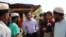 FILE - Rohingya Muslim leader Mohib Ullah speaks to other Rohingya people in Cox's Bazar, Bangladesh, April 7, 2019. Gunmen killed Mohib Ullah in a refugee camp in southern Bangladesh Sept. 29, 2021, a U.N. spokesperson and a local police official said.