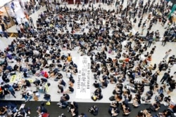 FILE - Anti-extradition bill demonstrators attend a protest at the arrival hall of Hong Kong Airport, China, Aug. 9, 2019.